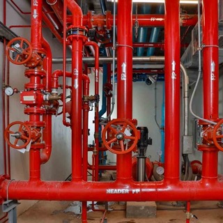 A wall-mounted fire extinguisher and hose reel